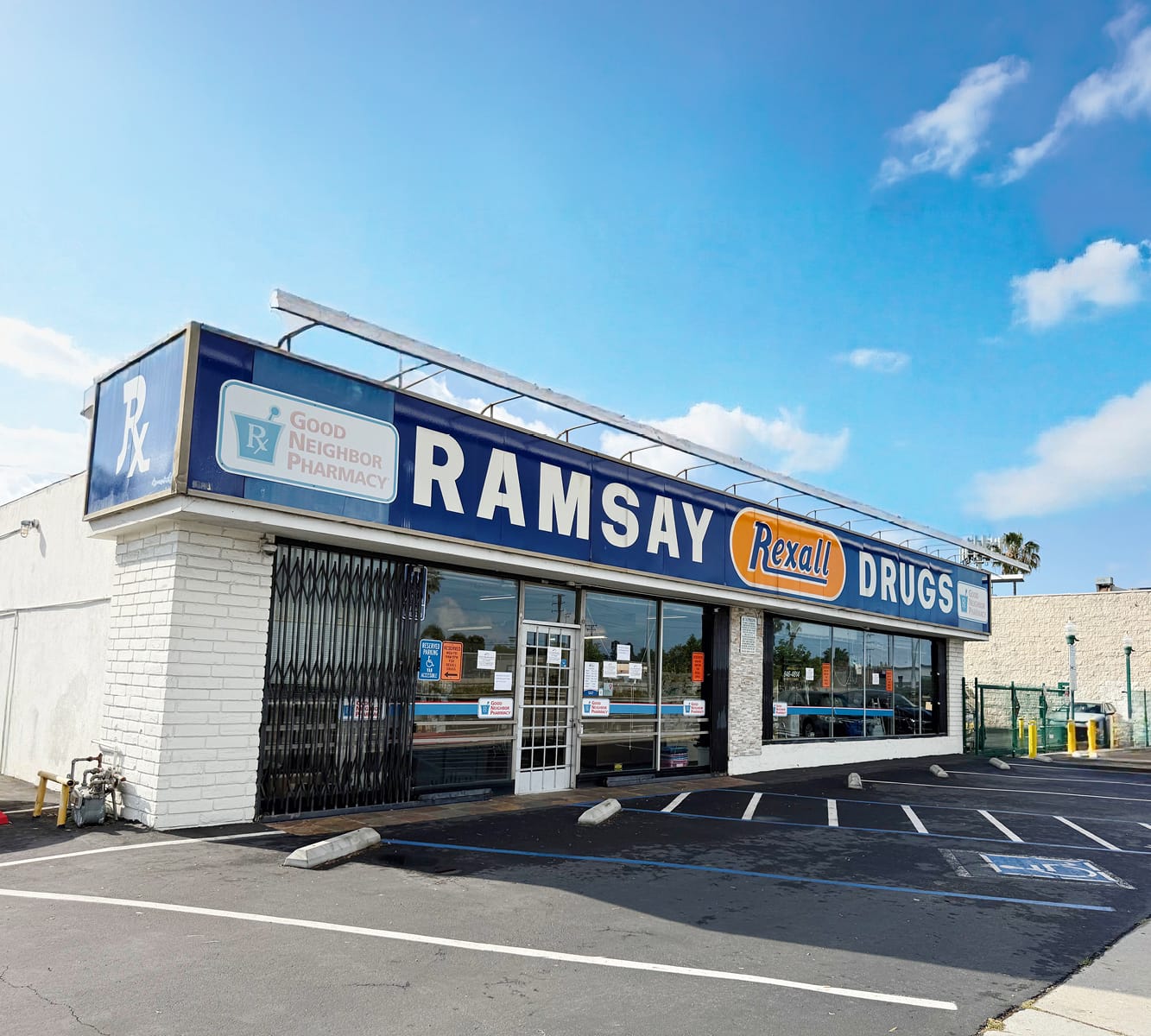 white building with blue, white, and orange sign that says Ramsay Drugs