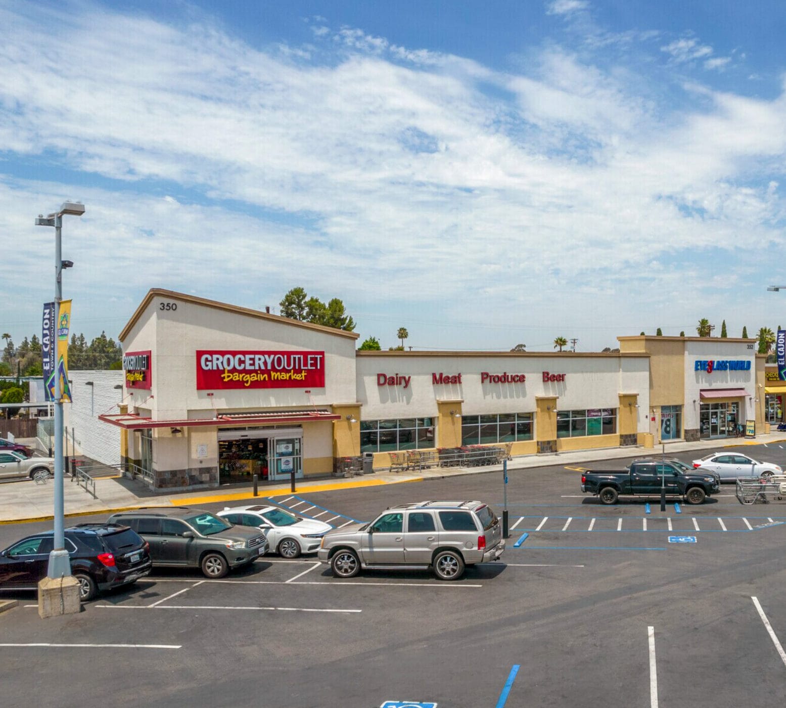Former Grocery Outlet building at 350 N 2nd St with a large parking lot in front and Eyeglass World to the right.