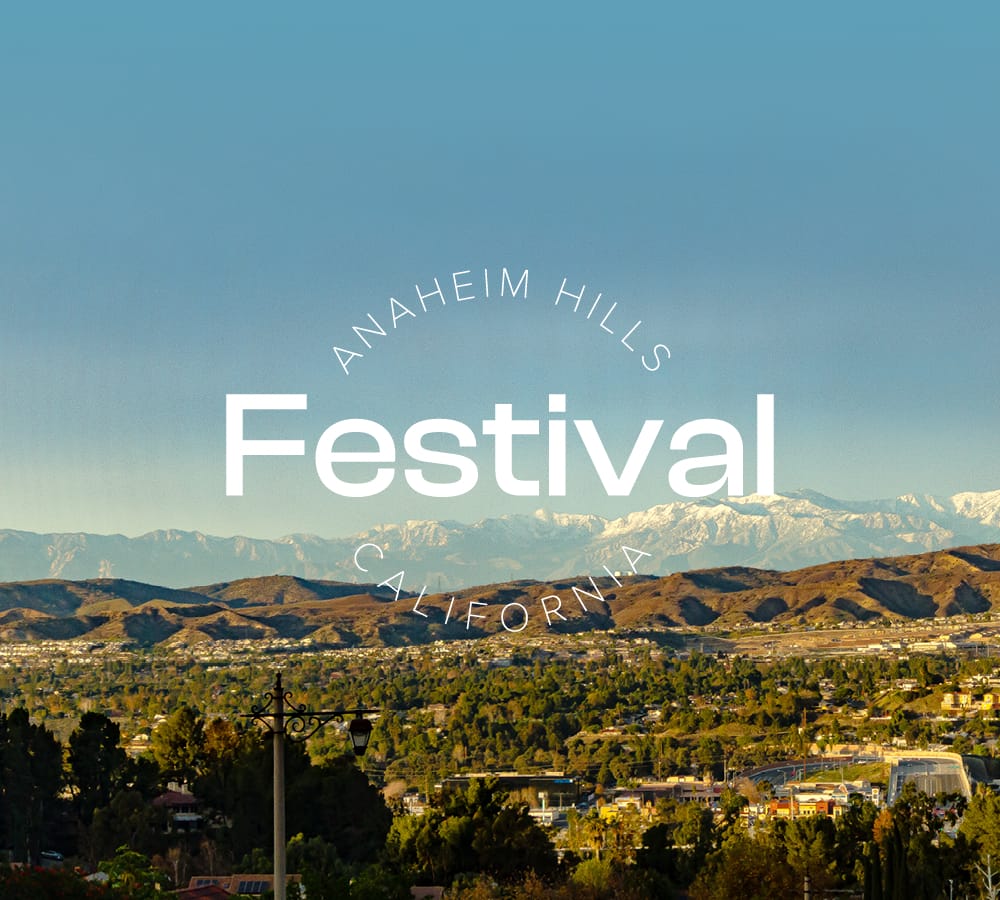 mountains with blue sky and text overlaid that says Anaheim Hills Festival California