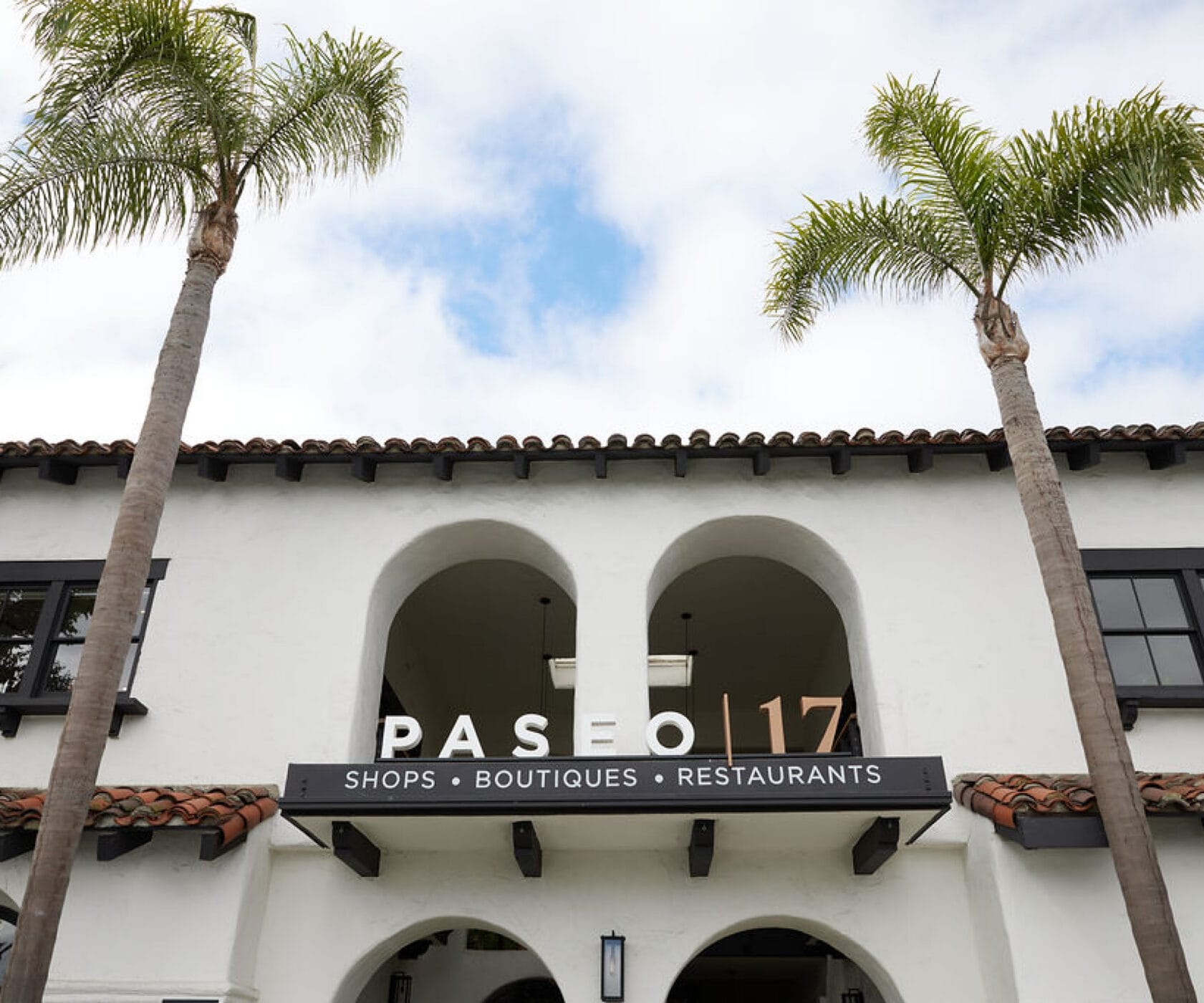 Paseo 17 sign above an arched entrance.
