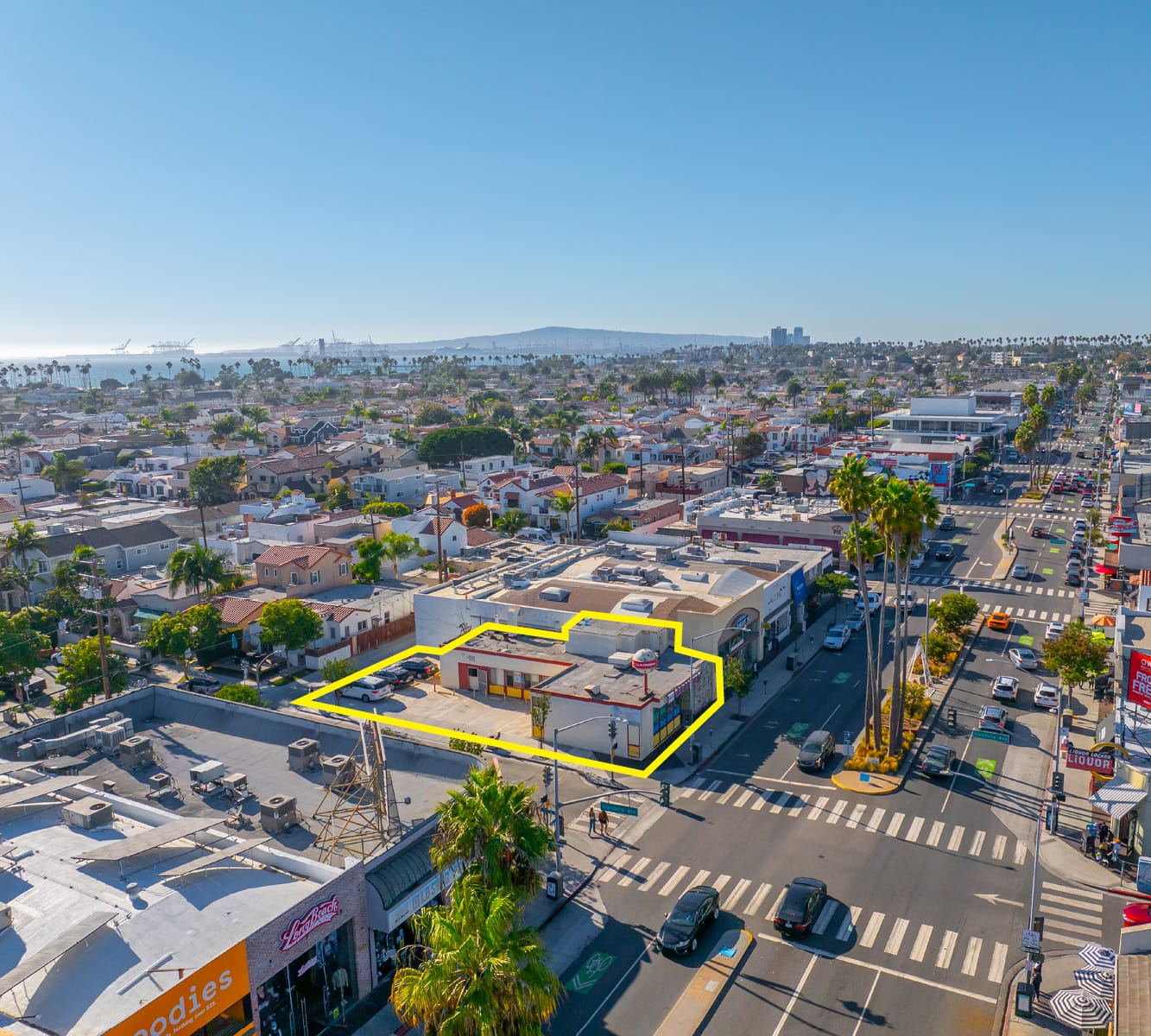 Aerial view of a building outlined in yellow with blue skies