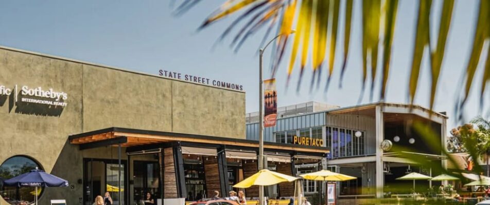 Coastal storefronts featuring a variety of retail shops with palm trees surrounding