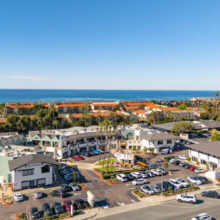 Aerial view of a beach with a shopping center below