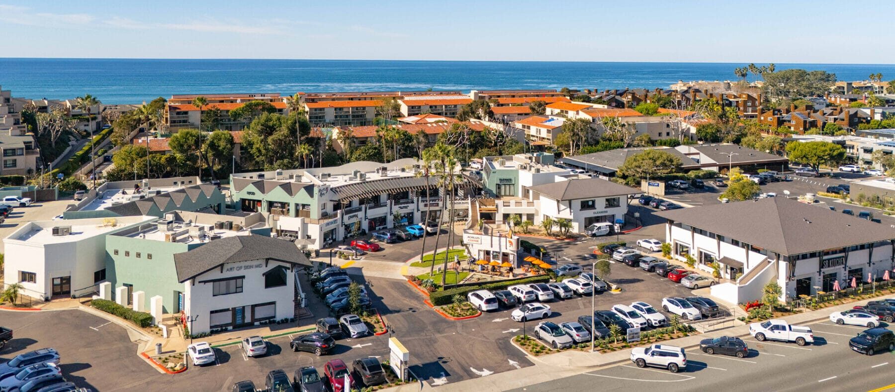Aerial view of a beach with a shopping center below