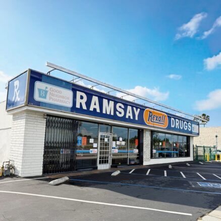 white building with blue, white, and orange sign that says Ramsay Drugs