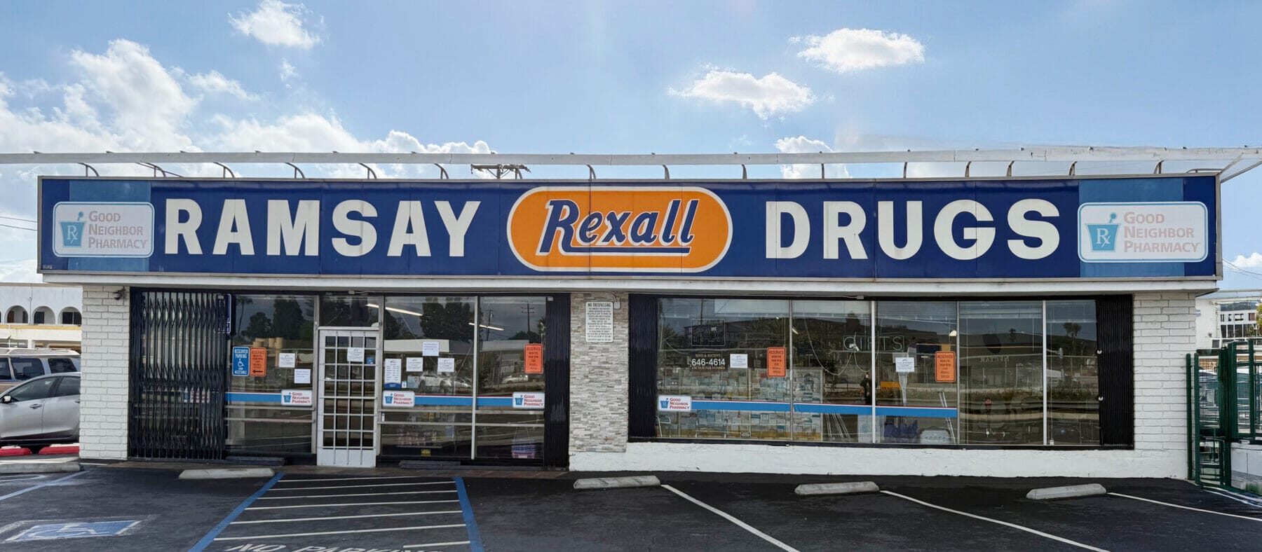 white building with blue, white, and orange sign that says Ramsay Drugs