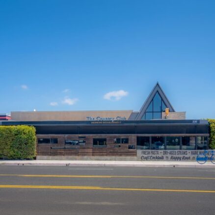 Exterior view of The Country Club building in Costa Mesa. Brown building, single story