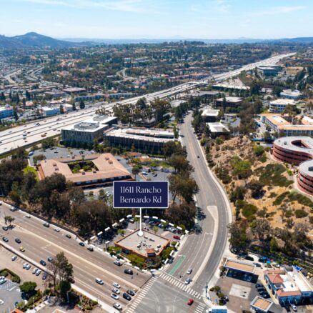 Aerial of 11611 Rancho Bernardo Rd with the intersection of Rancho Bernardo Rd and Bernardo Rd in front and the I-15 freeway behind.