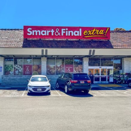 Strip mall, single story building with red sign