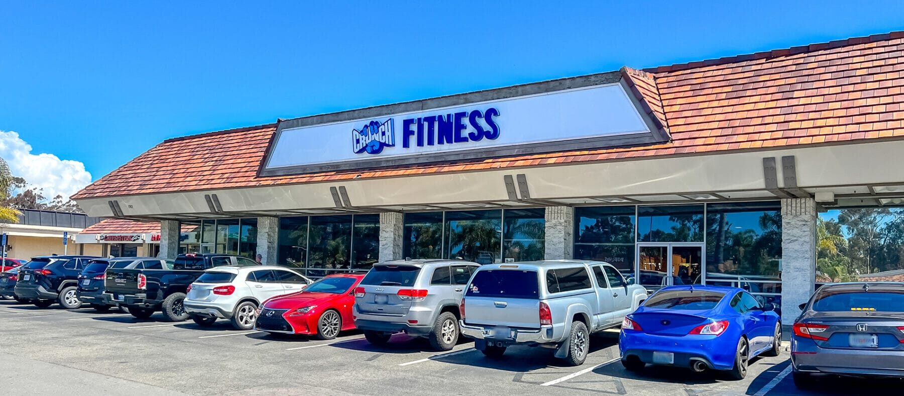 Strip mall, single story building with white and blue sign