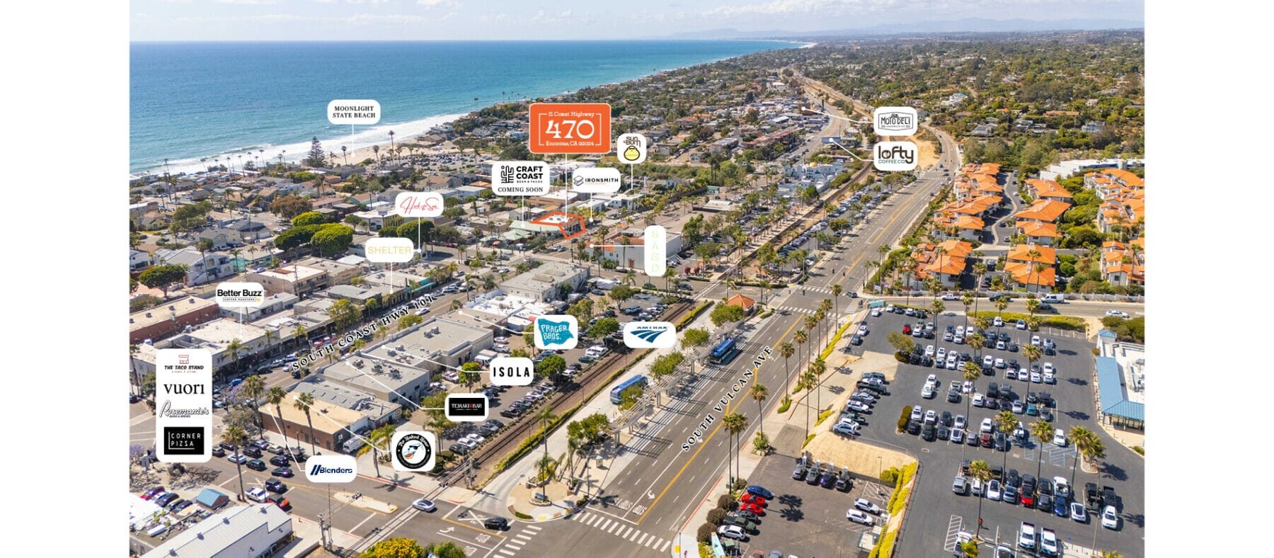 Aerial view of Encinitas, CA with the ocean to the left and buildings on the right