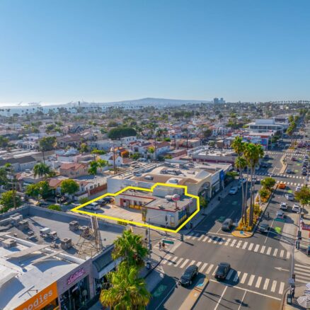 Aerial view of a building outlined in yellow with blue skies