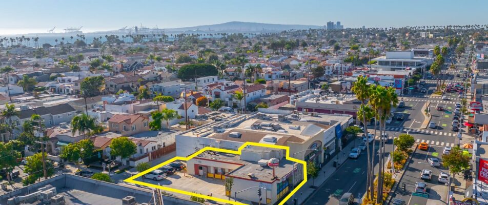 Aerial view of a building outlined in yellow with blue skies