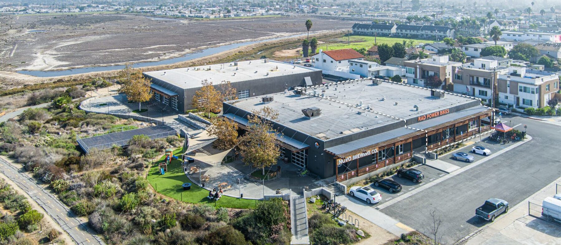 Aerial view of 535 Florence St with the Bayshore Bikeway Trail in front and the building at 536 13th St behind.